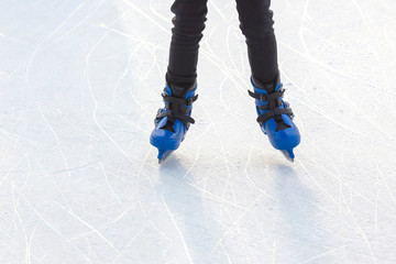 man actively rides in blue skates on an ice rink. Hobbies and sports. Vacations and winter...