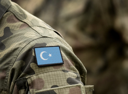 Flag of East Turkestan on military uniform. Islamic Republic of East Turkistan. Flag Kok Bayraq a symbol of the East Turkestan independence movement. Collage.