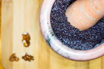 handmade preparation of treats for traditional Orthodox Christmas - mortar with poppy seeds, dried...