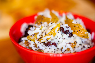 handmade preparation of treats for traditional Orthodox Christmas - rice pudding with fruits, cranberries, honey, nuts, Church candles