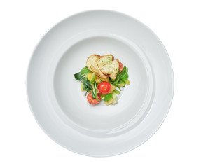 vegetable salad in a large white plate. tomatoes. the view from the top