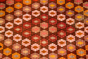 Turkish carpet with pattern has a red ornament and woven by the craftsmen of Cappadocia.