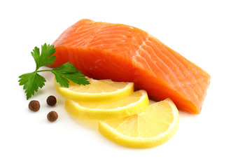 Red fish. Raw salmon fillet with parsley, peppercorns and lemon isolate on white background