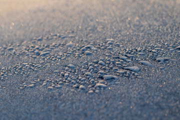 texture. shallow depth of field. soft focus. frost frost on blue metal.