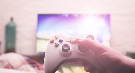 A man is playing a game while lying on the floor. Playing on the console. © alexkich
