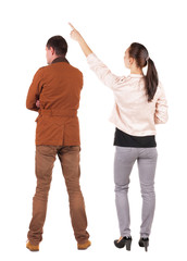 Fototapeta premium Back view of a stylish couple pointing.