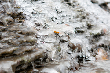 Iced small river stone on winter time