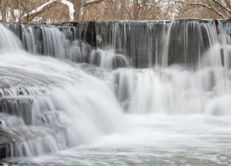Small river cascade step on winter 