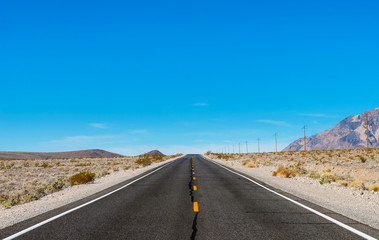 The road passing through the desert.