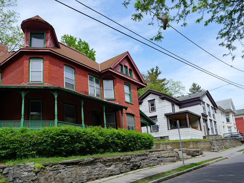 Street with old houses with large porches near Cornell University