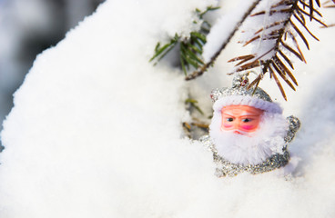 Beautiful winter scene. Santa Claus in a silver suit in the snow. Christmas decoration. Christmas winter background. Christmas, New Year concept. Santa Claus in the winter forest. Christmas toy.