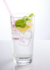 A glass of mineral water decorated with a slice of orange and mint - 308315837