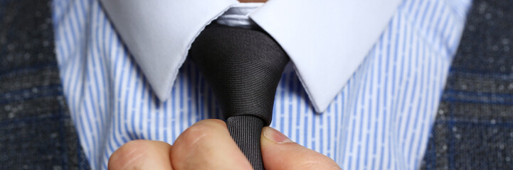 Male arm in blue suit set tie closeup