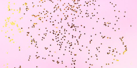 Festive bright pink color background with golden star falling confetti. Christmas, new year or other holiday backdrop banner