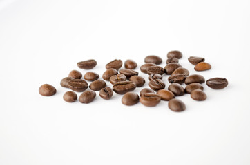 Coffee beans isolated on the white background. Grains of coffee close-up. Selective focus