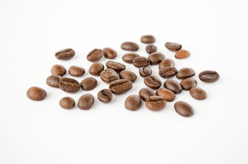 Roasted coffee beans isolated on the white background. Grains of coffee close-up. Selective focus