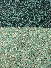 Dark and light green textured granular background