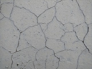 Grey painted wall with cracks