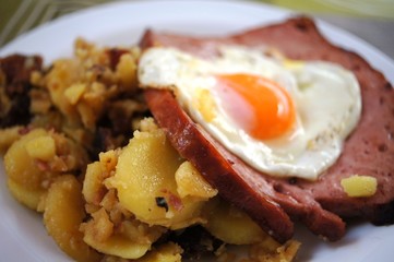 Bavarian food Leberkäse with egg and fried potatoes