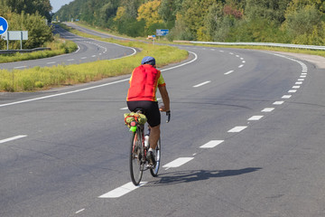 Cyclist rides on the highway on a bicycle