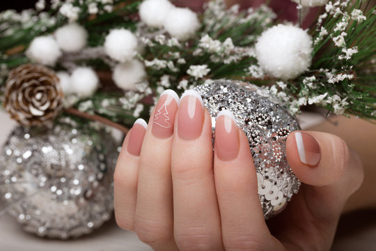 Snow White manicure on female hands. Winter nail design.