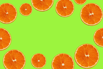 set with juicy slices of orange on a green background for a menu or recipe, the concept of vegetarian, vitamin and healthy food, background, pattern for textile, wallpaper, copy space