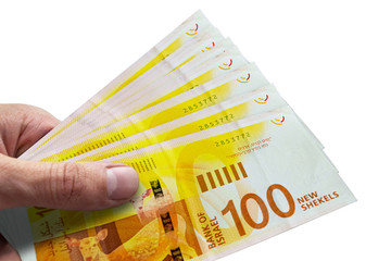 Hand holding Israeli shekels. ILS. Money of Israel.