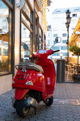 Red vintage scooter parked on the street in Budapest, Hungary