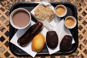 Cup of coffee with assorted desserts in top view