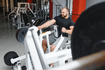 Young handsome man engaged in the gym