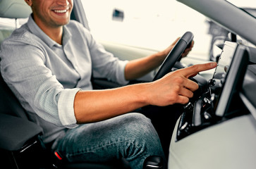 Cropped image hand of man using navigation system while driving a car.