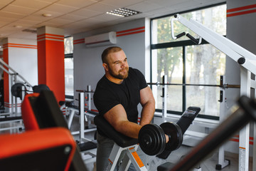 Fototapeta na wymiar Young handsome man engaged in the gym