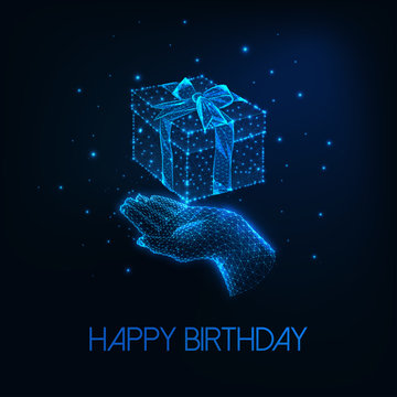 Futuristic happy birthday greeting card with glowing low polygonal human hand holding gift box