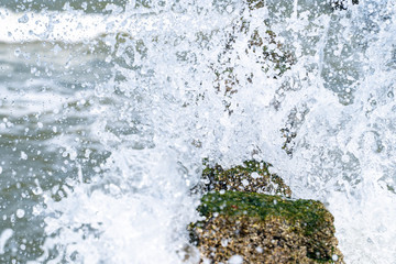 Close up beach poles splashed by water at the sea coast