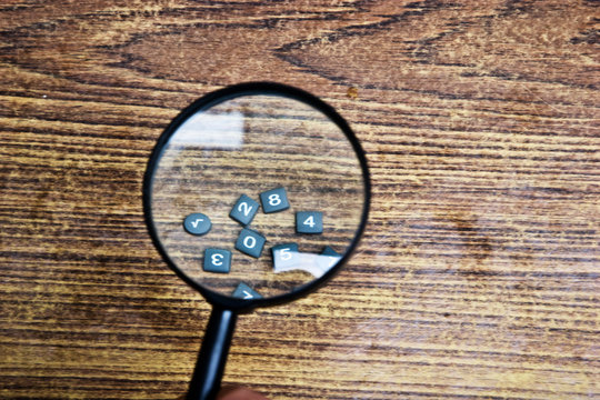 Keyboard under a magnifying glass close-up.