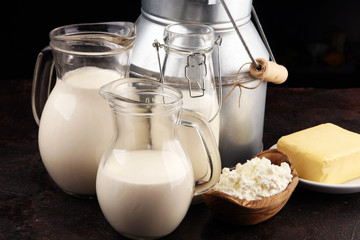 Different  healthy dairy products on rustic background with milk, cheese, butter and cottage