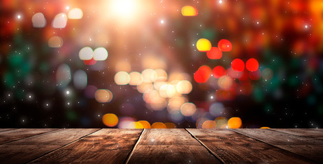 Wooden table, blurred bokeh background background. Neon light, night view, close-up. The general...