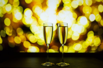 Two glasses of champagne on a bokeh background. Close-up isolated background.