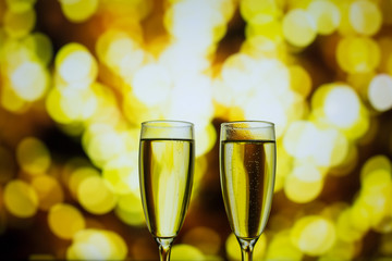 Two glasses of champagne on a bokeh background. Close-up isolated background.
