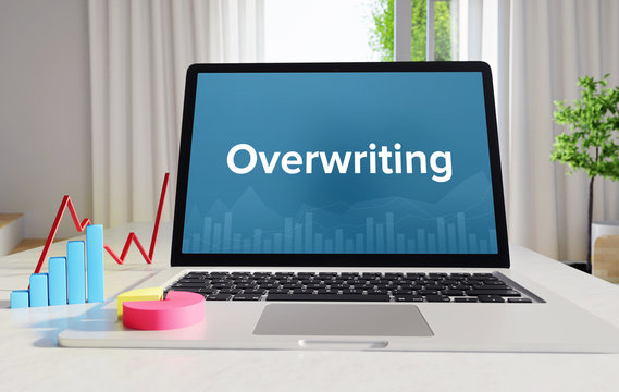 Overwriting &ndash; Statistics/Business. Laptop in the office with term on the Screen. Finance/Economy.