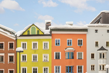 Fototapeta na wymiar Bright multicolored facades of old medieval buildings in historical center of famous alpine austrian town Kufstein in Austria Europe. Colorful houses in small european city center with blue clear