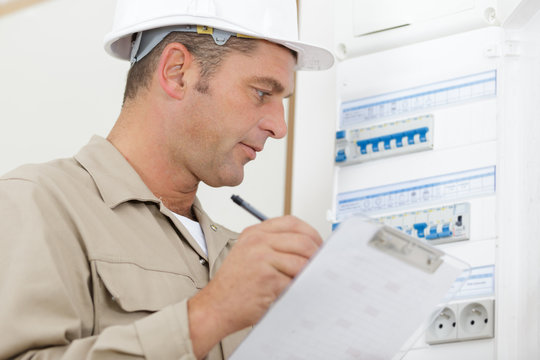 an electrician supervising fuse board