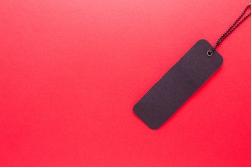 Black label on red isolated background close-up.