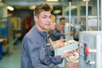 young male factory machine operator
