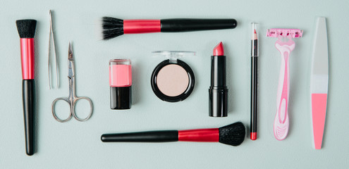 Set of woman make up cosmetics on mint background. Beauty and fashion concept. On table lies...