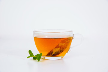 Mint and brewed mint in a cup on a white background. The concept of using herbs and spices at home. Herbs for stomach problems.