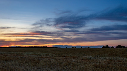 Colorful sunset in rural landscape with cloudy sky in M&ouml;ckm&uuml;hl, Germany