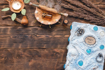 Book of magic on wizard table concept background. Shaman accessories.