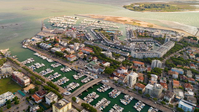 Marina Punta Faro in town Lignano Sabbiadoro Italy. Marano Lagoon meet Adriatic Sea, creating wonderful contrast of colours. Yacht Club, Bau beach Lignano, Cafe, Restaurants and hotel. Shipyard summer