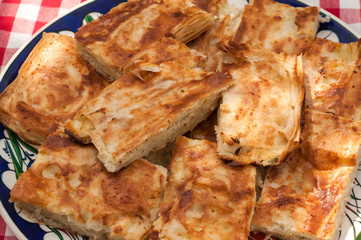 Pieces of traditional homemade filo pastry filled with white cheese